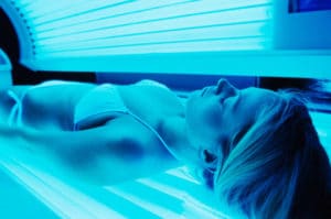 girl wearing a bikini in a tanning bed